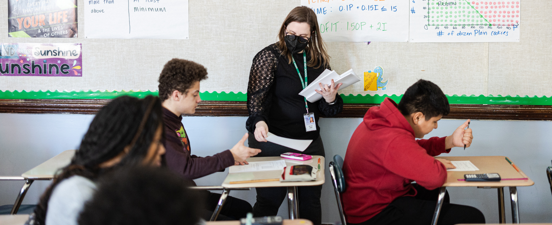 A Senn High School teacher assists students